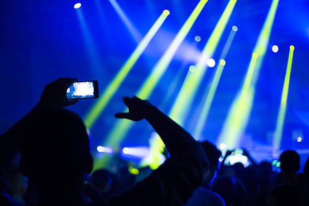 istock taking pictures  during a music concert 500233402
