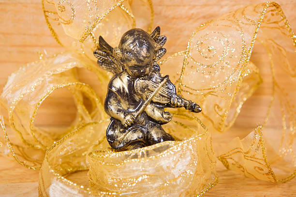 istock Wood angel on gold surface 500234654