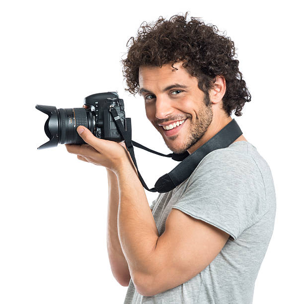 young man holding reflejo - single lense reflex fotografías e imágenes de stock