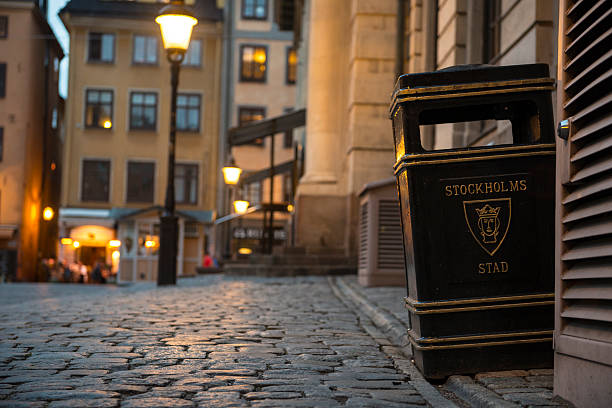 Stockholm, Sweden - June 21, 2015: Scene late on a summer night on Stortorget Square in the historic Gamla Stan area of Stockholm, Sweden. A garbage bin is on the right.