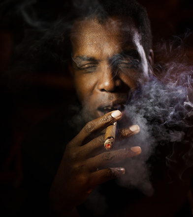 african american man smoking a cigar on a club