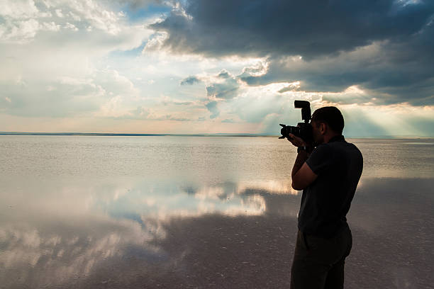 istock Man Photographing in Water at Sunset 500238709