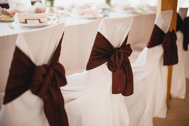 istock Row of wedding chairs with brown ribbons. 500252408