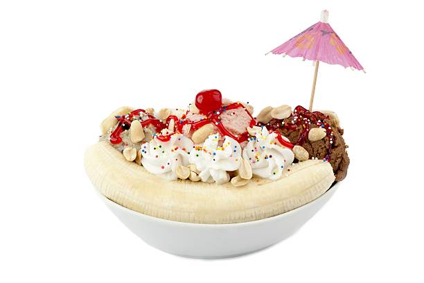 istock plate with banana spit and whipped cream top with cherry 500253318