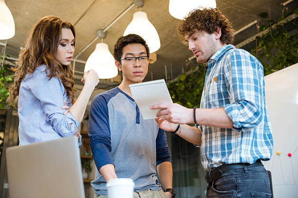 istock Smart  man sharing his ideas with concentrated coworkers 500253620