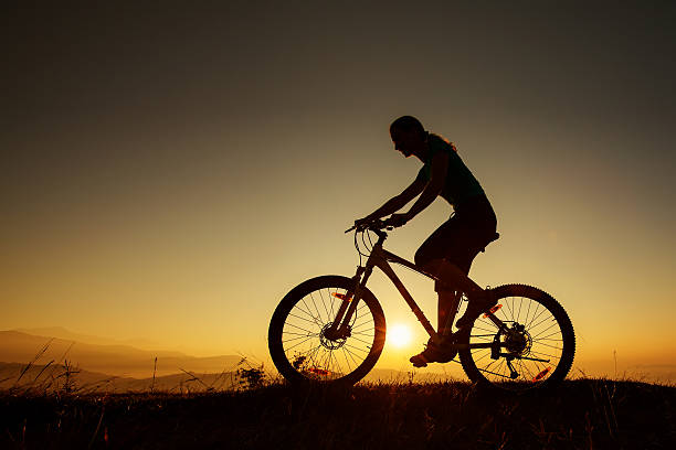 istock Biker-girl at the sunset on mountains 500254270