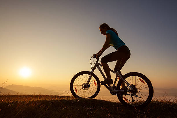 istock Biker-girl at the sunset on mountains 500254310