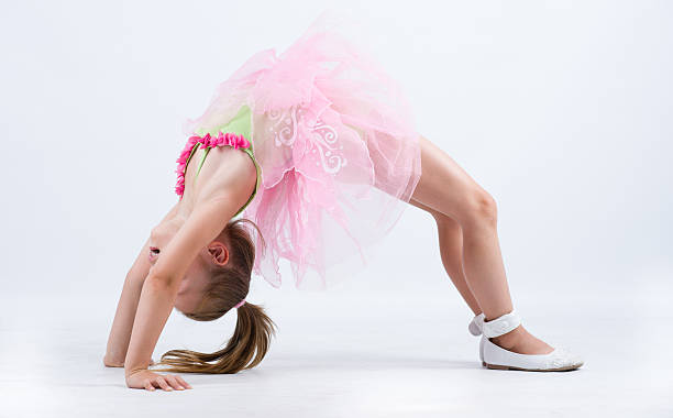 istock Little ballerina girl back bend bridge 500255313