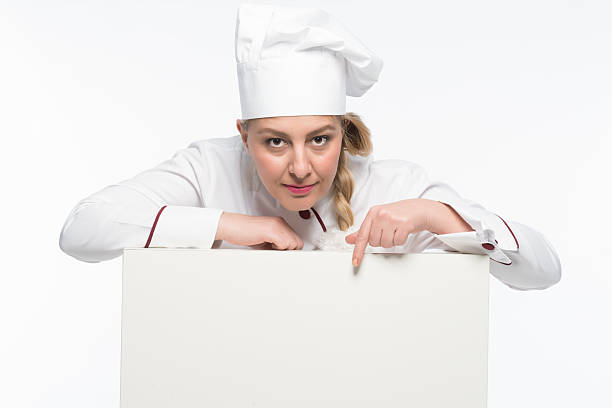istock Mean cook chef pointing finger to the blank menu 500255823