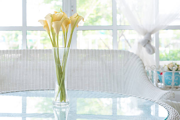 istock Yellow flower in vase on table and window sill background. 500255943