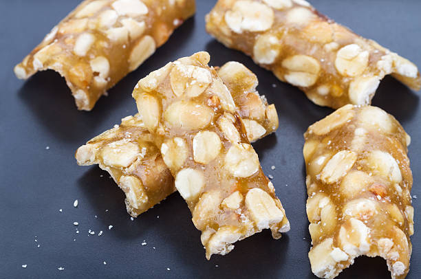 istock Crispy sweet peanut stick on black plate 500256244