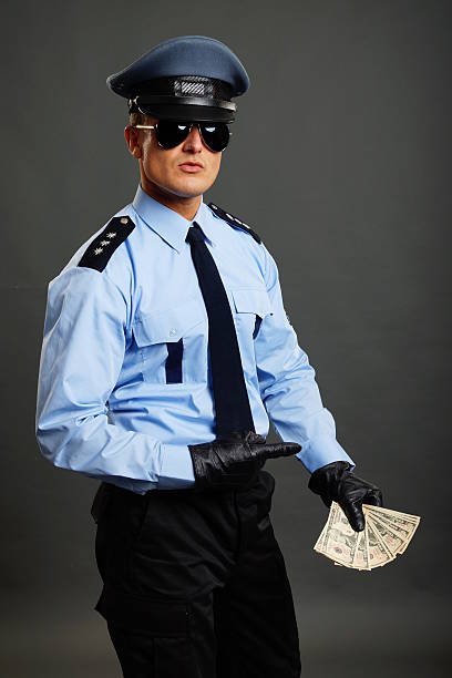 istock Policeman shows money 500259173