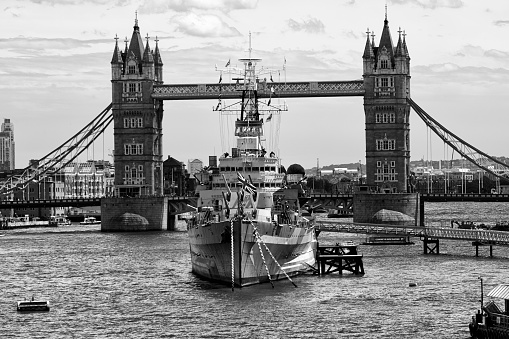HMS Belfast, moored up safely near Tower Bridge in London.