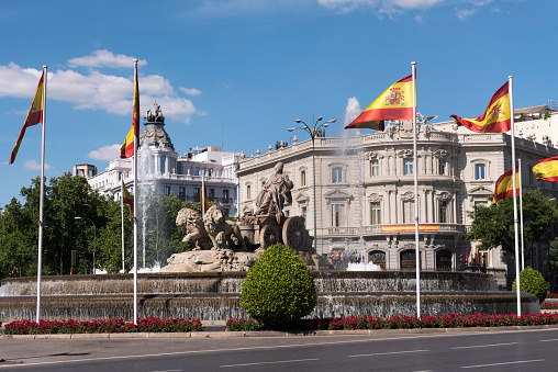 Statue of Cibeles, decorated with the flags of Spain and House of America of the background