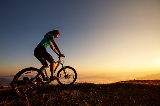 istock Biker-girl at the sunset on mountains 500260728