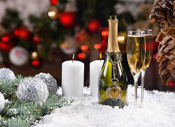 istock Festive Champagne and Candles on Snowy Surface 500261418