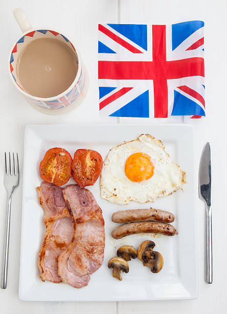 istock fried english breakfast with british flag and tea 500262477