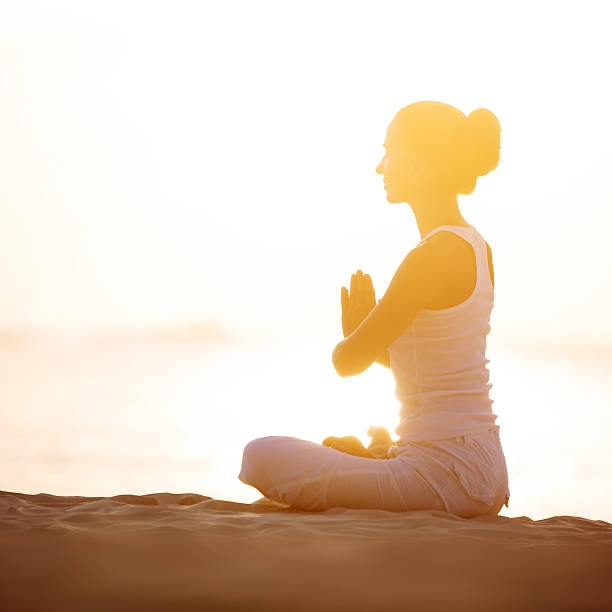istock Caucasian woman practicing yoga at seashore 500262700