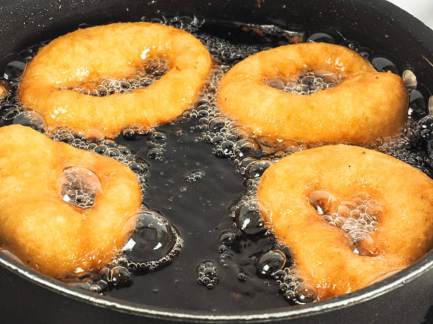 istock Closeup of doughnuts boiling 500263596