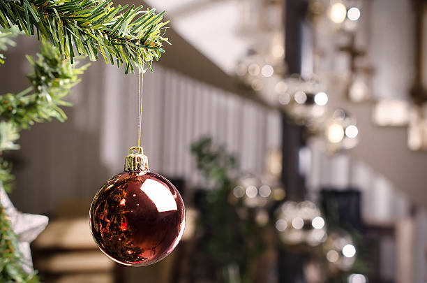 red christmas decoration hanging on christmas tree - soft focus - christmas tree stockfoto's en -beelden