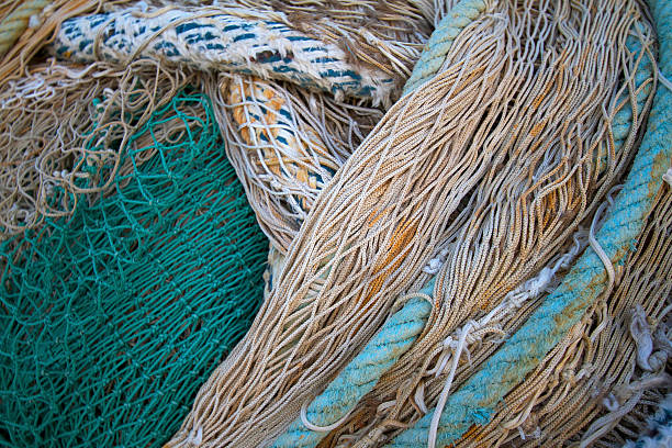 istock Tangled Green and White Fishing Nets, Ropes, Close-Up Full Frame 500264556