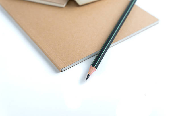 istock white sketch book and pencil on white 500264866