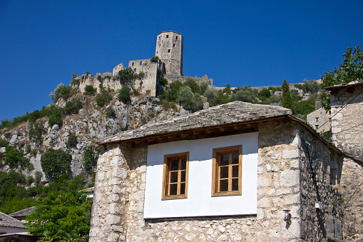 Pocitelj, Bosnia and Hercegovina - September 1, 2015: Počitelj is a town in the Čapljina municipality, Federation of Bosnia and Herzegovina, Bosnia and Herzegovina. The historic site of Počitelj is located on the left bank of the river Neretva, on the main Mostar to Metković road, and it is to the south of Mostar. The period of the settlement development under the Ottoman Empire with the erection of public buildings: mosques, imaret (charitable kitchen), mekteb (Muslim primary school), medresa (Muslim high school), hamam, baths, han (inn) and the sahat-kula (clock-tower) (1471–1698).
