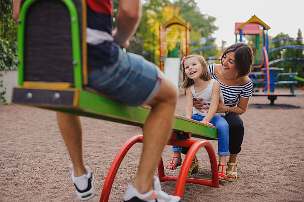 istock Family having fun on a swing 500265068