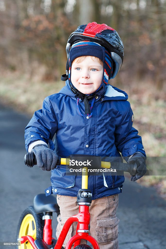 2 years old toddler riding on his first bike Cute boy having fun outdoors with his first bike Activity Stock Photo