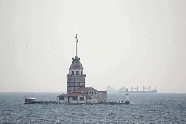 The Maiden's Tower is one of the main landmarks of the Turkish city of Istanbul. It is located in the Bosporus roughly 200 m from the asiatic shore and today houses a restaurant. Besides general interest, it has become widely known for appearing prominently in the James Bond movie "The World is not enough". The present image was taken in hazy conditions and shows the tower looking south, in the direction of the Sea of Marmara. Some freighters can be seen in the background.