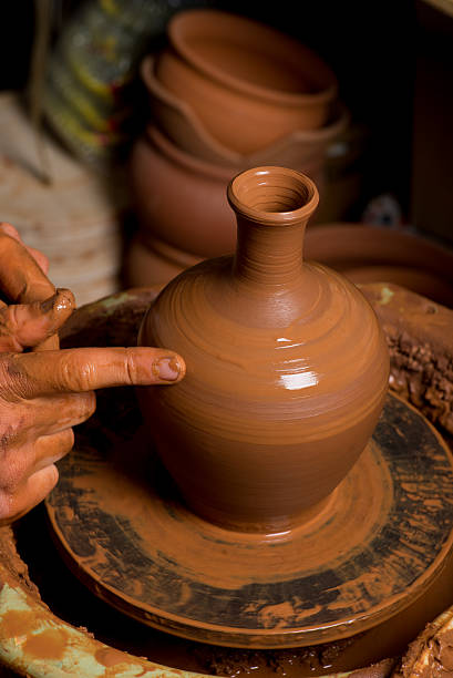 istock hands of a potter, creating an earthen jar 500276915