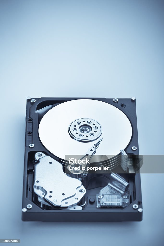 HDD on blue vertical an opened hard disk on white background Accessibility Stock Photo