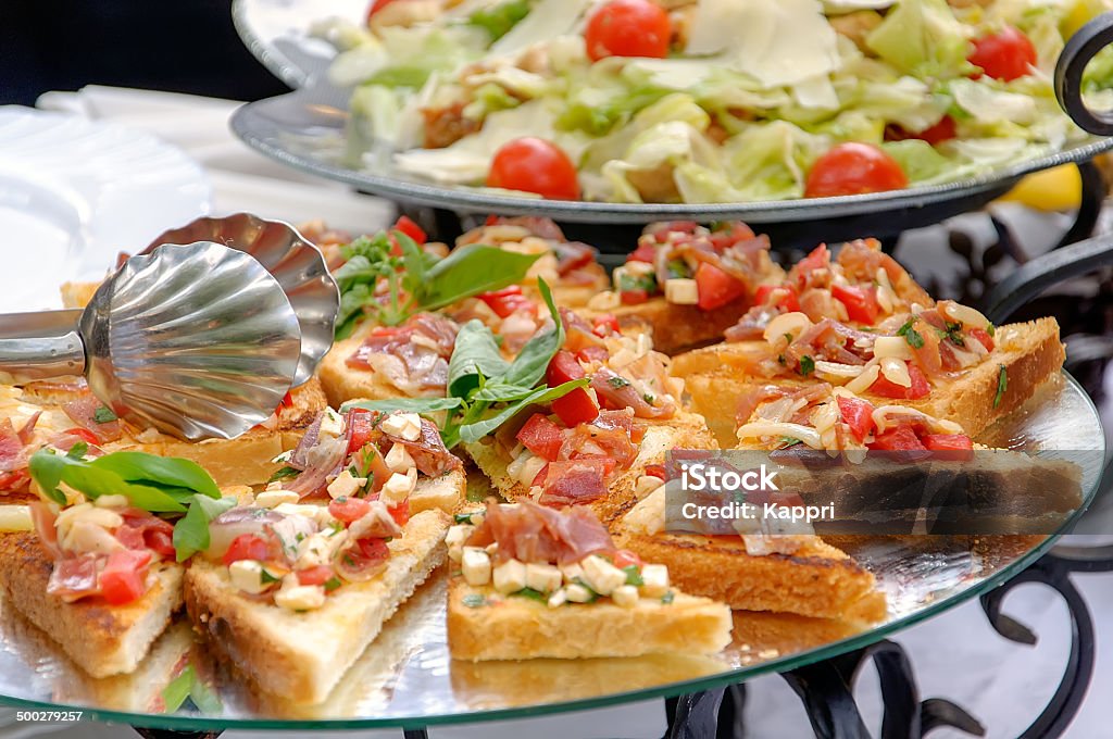 Bruschetta and Caesar salad Bruschetta and Caesar salad on a plates American Culture Stock Photo