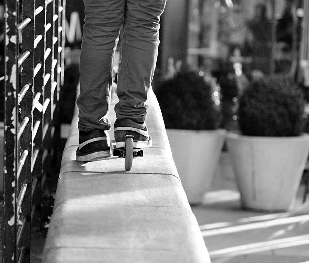 istock scooter rider riding along a wall 500281667