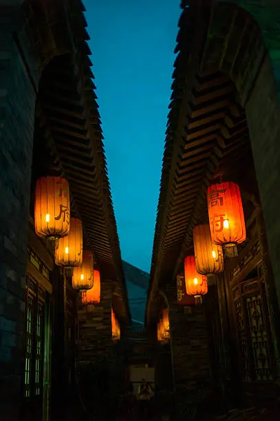 A traditional Chinese ancient house, hung red lanterns, Chinese lanterns is written on a surname in China.