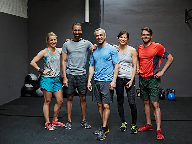 portrait of smiling gymters - side by side teamwork community togetherness foto e immagini stock