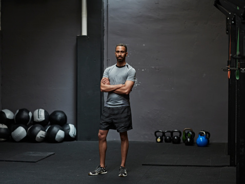 Portrait of male athlete looking at camera in gym gym