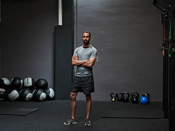 portrait of male athlete in gym gym - sportsman looking at camera full length sport imagens e fotografias de stock