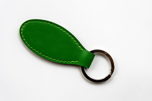 Green leather key chain isolated on white background. 