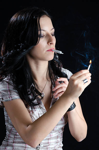 istock Woman Lighting Up a Cannabis Joint 500288887