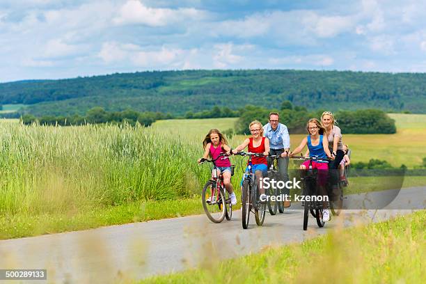 Family Cycling In Rural Landscape Stock Photo - Download Image Now - Family, Bicycle, Field Trip