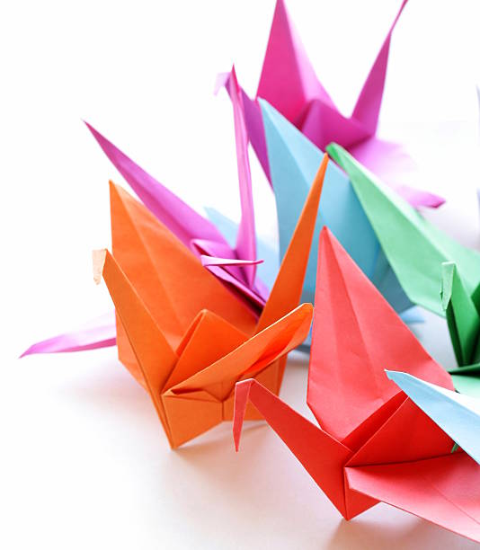 istock colorful paper origami birds on a white background 500289537
