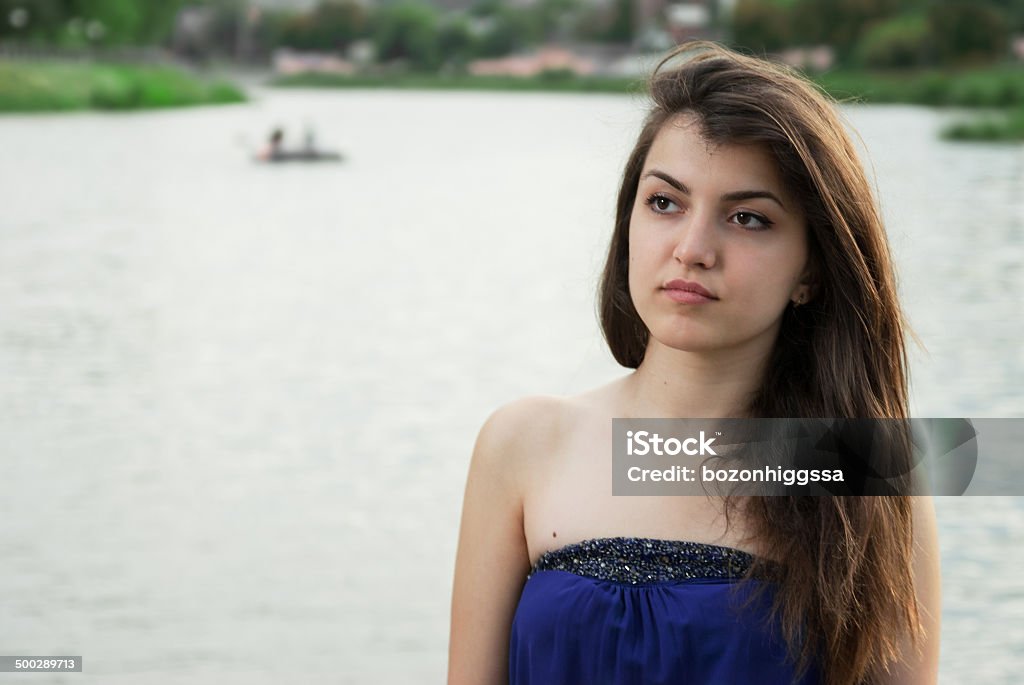 Beautiful Asian girl thoughtfully looks into distance Beautiful girl thoughtfully looks into distance at the river Adult Stock Photo