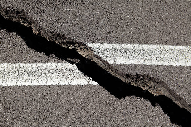 cracked asphalt stock photo