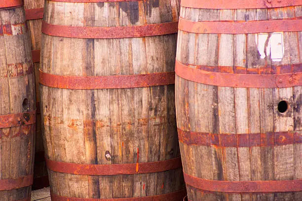 Three barrels stand as part of a maritime display.