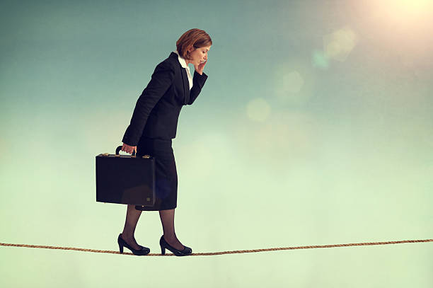 istock confident businesswoman walking a tightrope 500292017