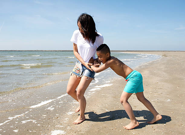 istock Mother and son playing at the beach 500292655