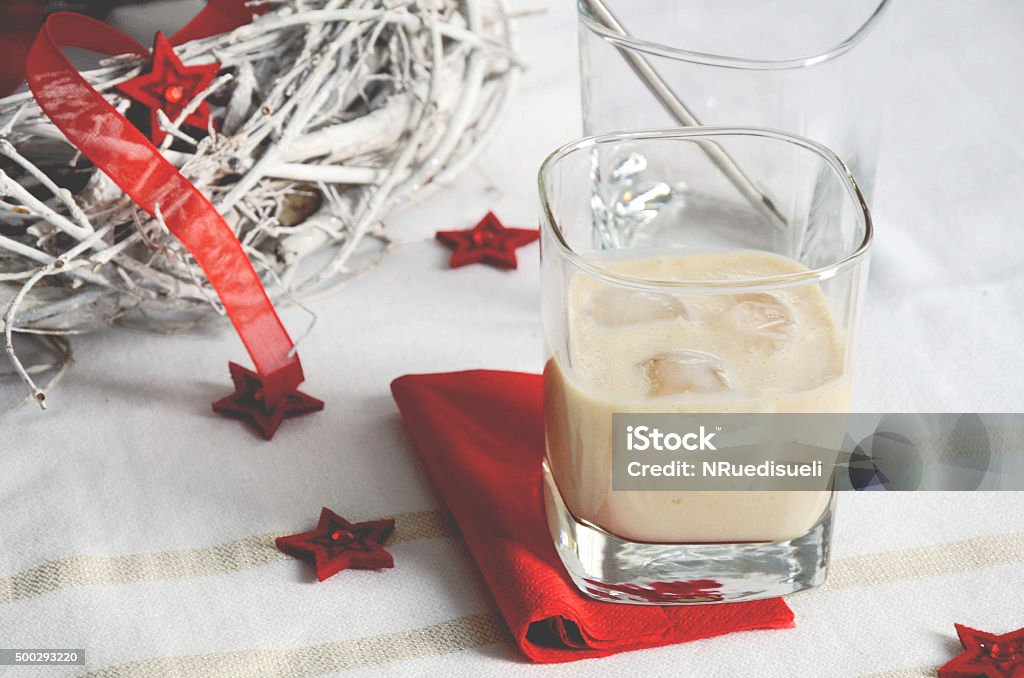 Irish cream cocktail with red deco items Irish cream cocktail served for Christmas on white background with red deco items 2015 Stock Photo