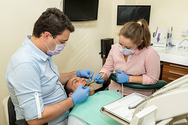 istock Dentist doing a dental treatment on a patient 500293222