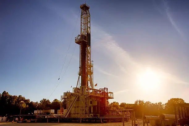 Photo of Drill Rig Fracking Operaton Silhouette at Dusk